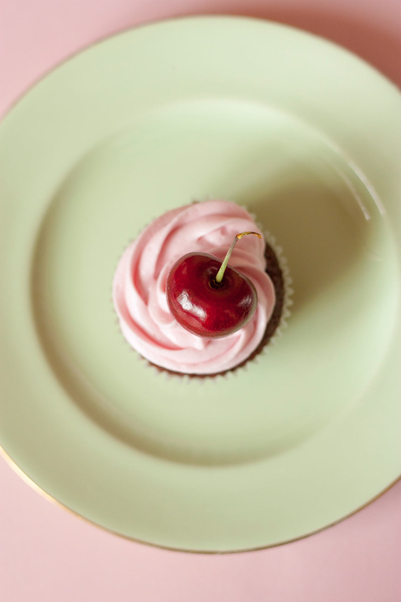 Cherry cupcake on a pastel plate